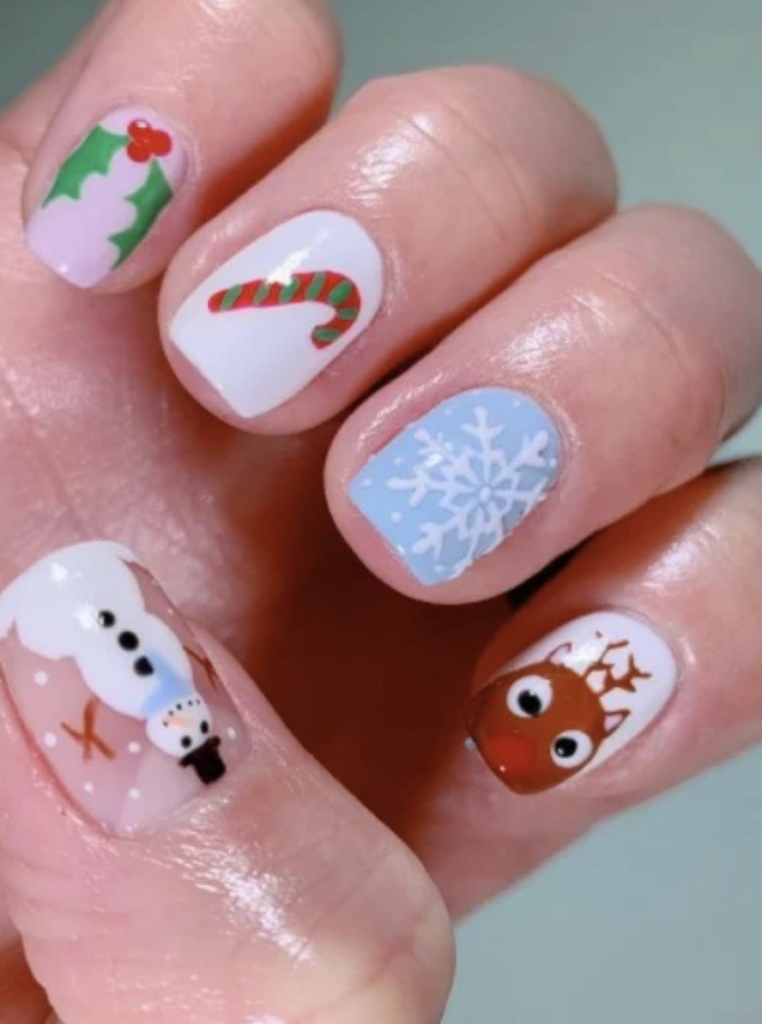 Nail art with icons of a mistletoe, candy cane, snowflake, reindeer, and a snowman. 