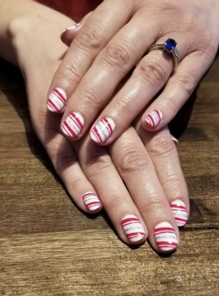 Candy cane nail art with white, red and silver stripes. 