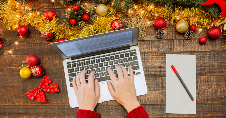 Canva image of a woman typing on a MacBook with a to-do list and holiday decorations around her.