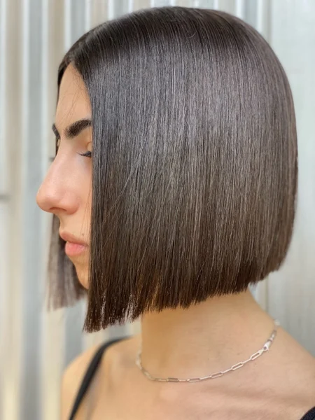 Photo of a woman with brown hair and blunt bob haircut