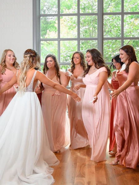 Photo of a bride doing a first look reveal with her bridesmaids. 