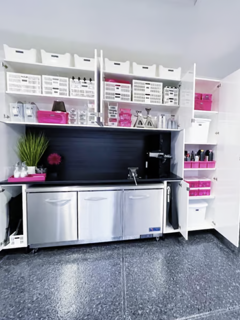 a garage that has been cleaned and organized with pink and white bins