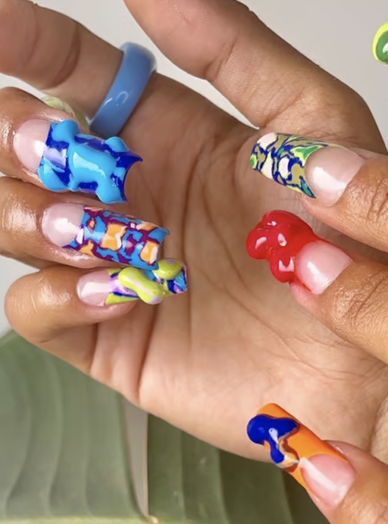 Long nails with bright and colorful designs and globs of paint. 
