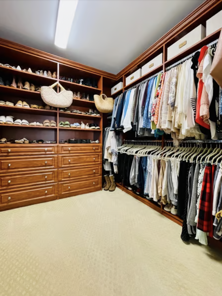 A large walk in closet that has been organized 