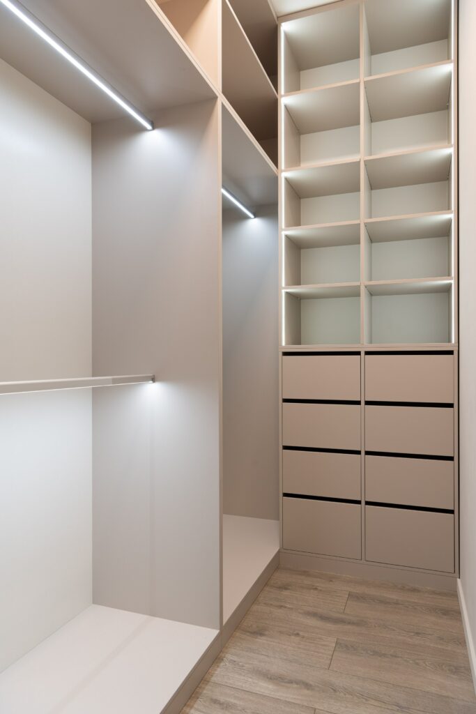 Stock photo of an empty walk in closet with white shelves 