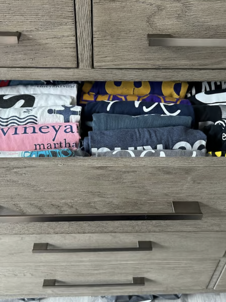 T shirts that have been folded neatly into a drawer 
