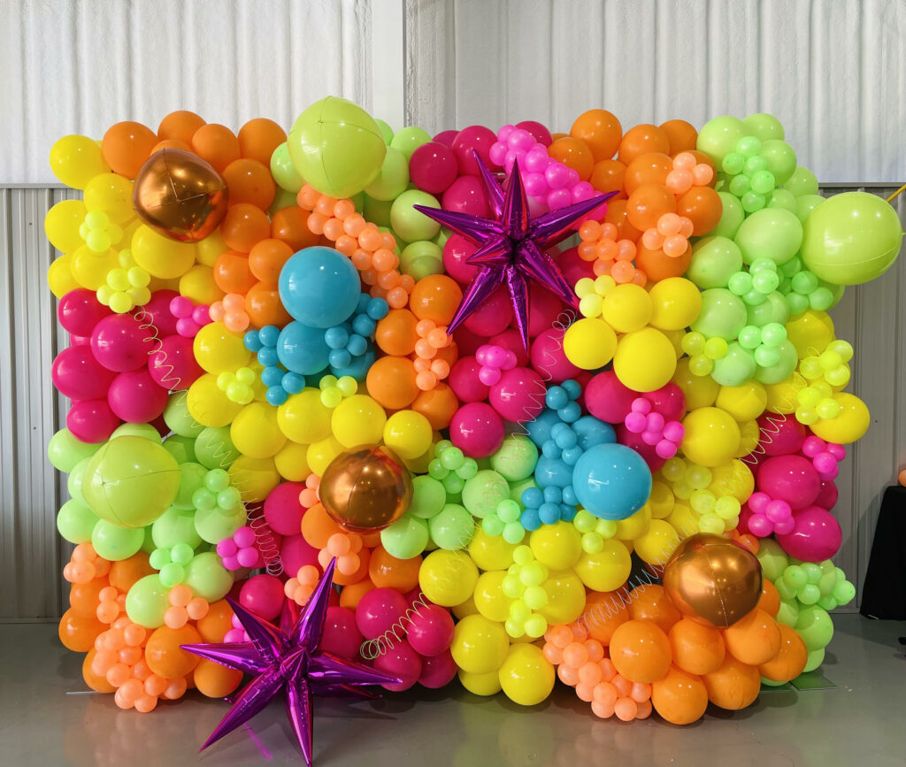 A 10ft balloon wall of neon colors with spark balloons added for dimension. 