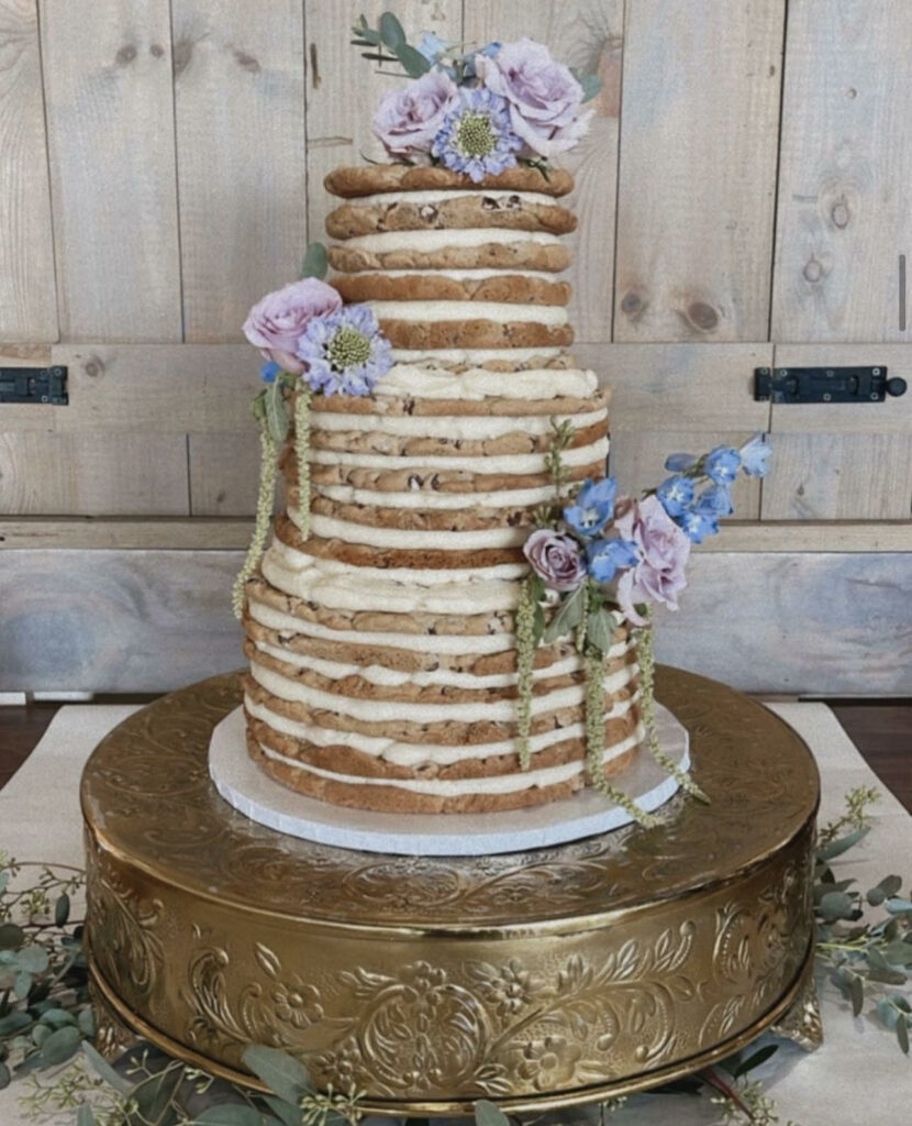 a three tiered wedding cake made out of layers of chocolate chip cookies and buttercream. 