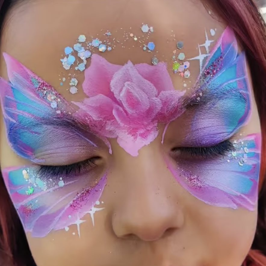 Blue, pink, and purple butterfly face paint over the eyes with a rose and glitter on the forehead.