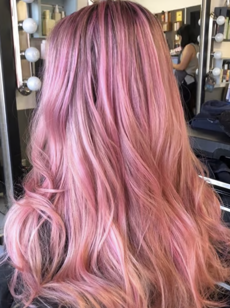 A woman with long, light pink hair. 