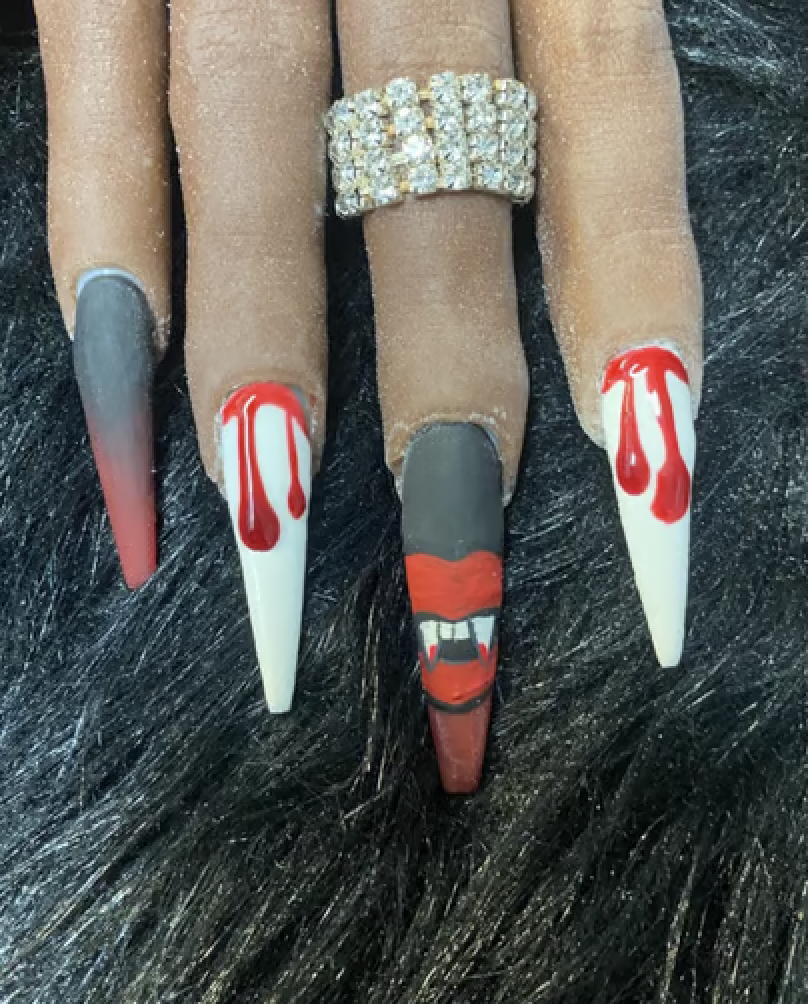 Black, white and red vampire inspired manicure with blood drips and fang decals. 