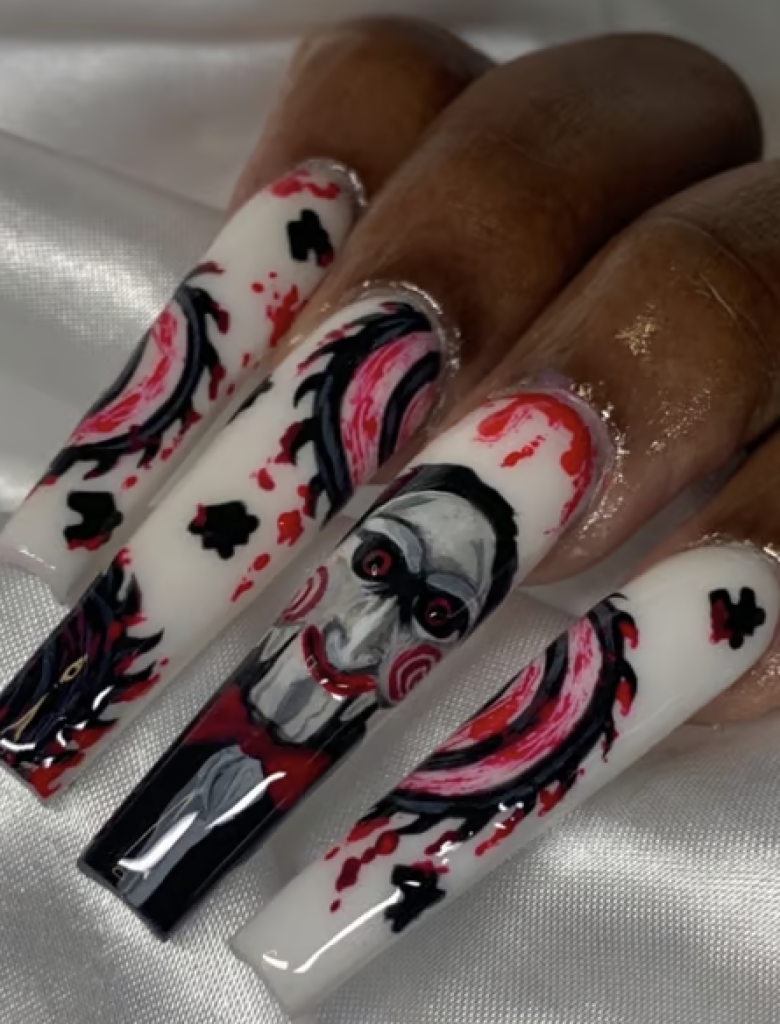 Long nails with a design based off of the movie "Saw." 