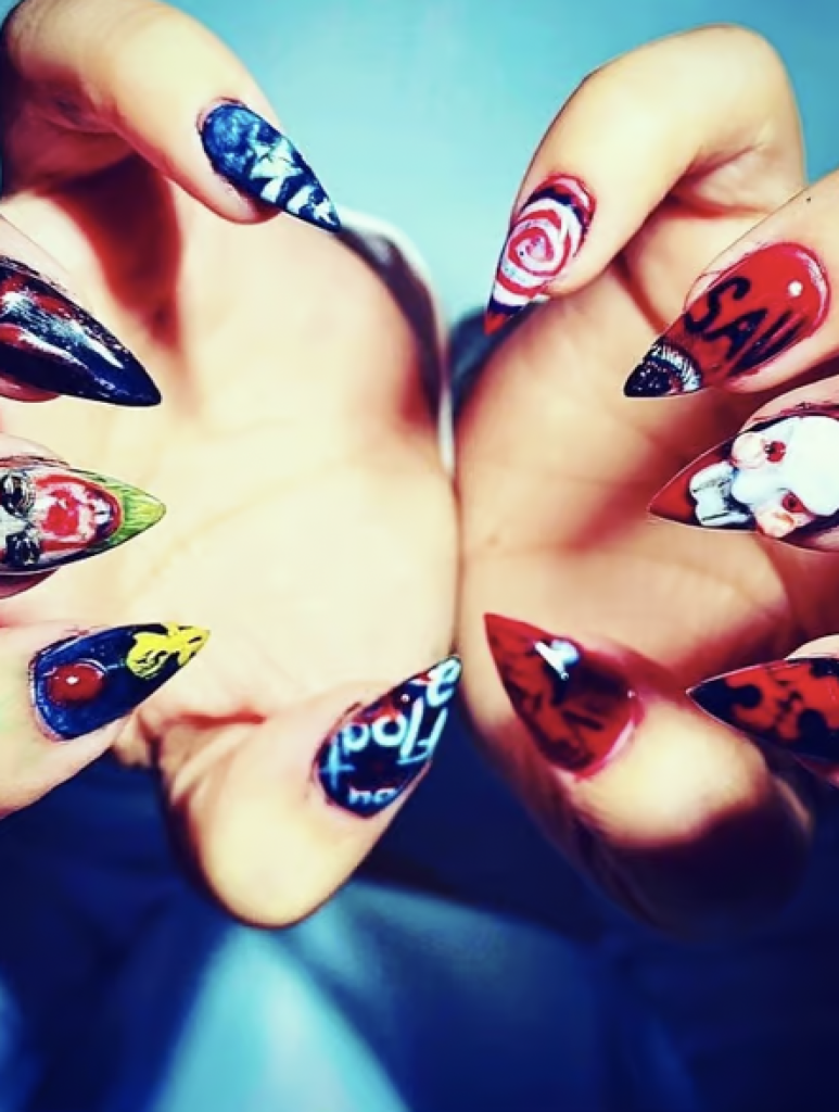 Halloween Manicure with pointed tips and different horror movie decals on each finger. 
