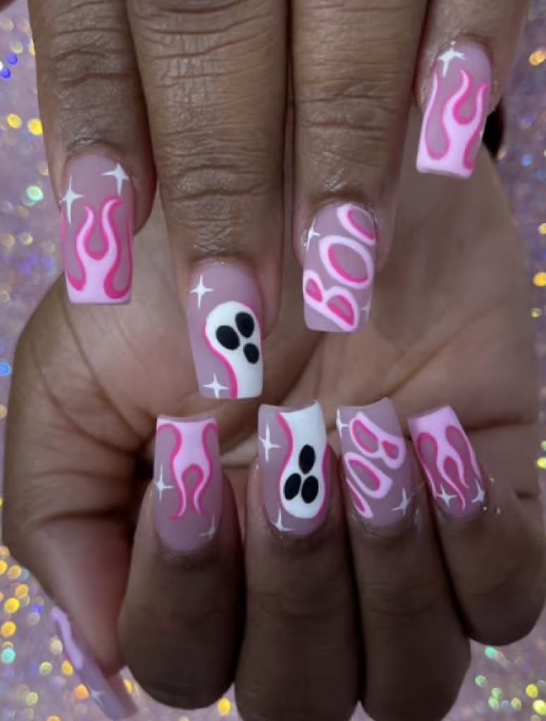 Halloween inspired light pink nails with pink flames and ghost decals. 