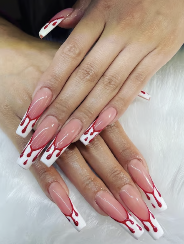 Long white french manicure with red blood drip decals on each nail. 