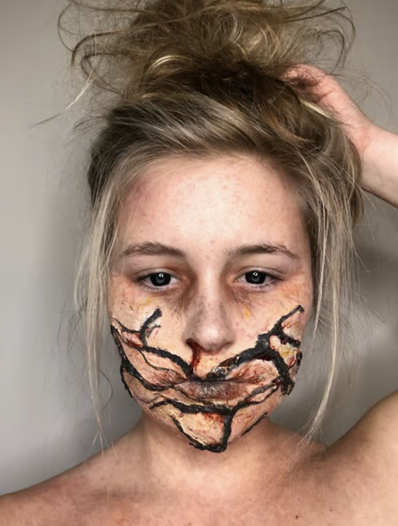 SFX Makeup with dark blood stains and a warped mouth 