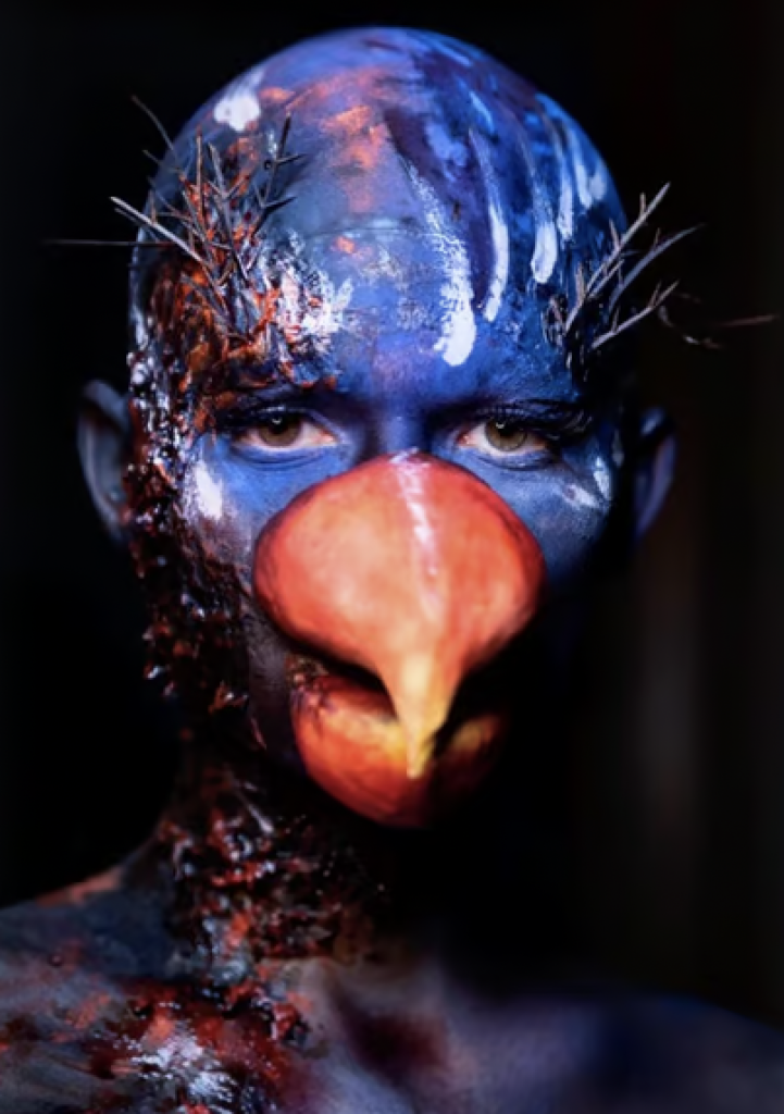Scary bird makeup with a blue face and orange beak
